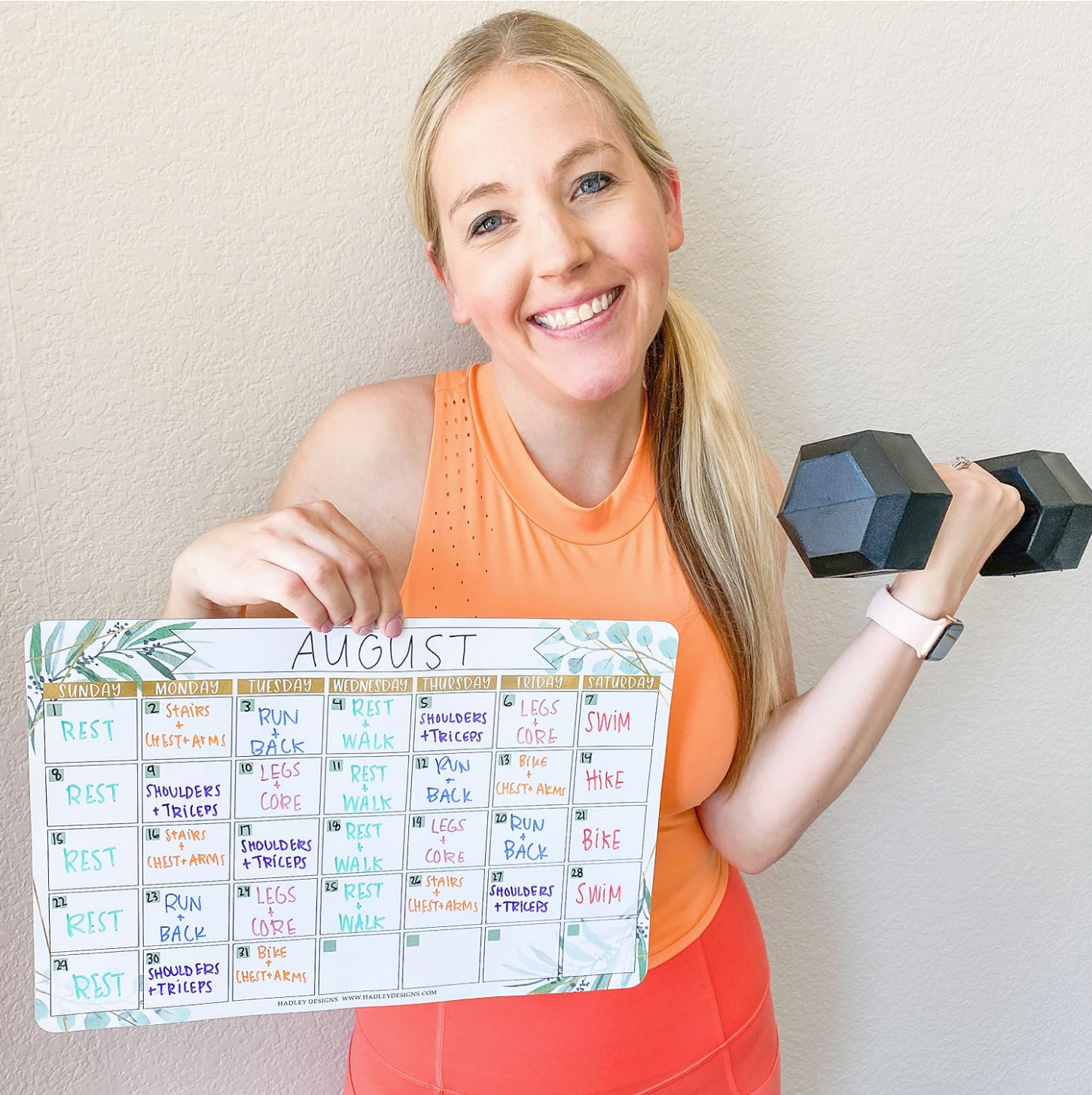 Becca showing a calendar used for planning workouts